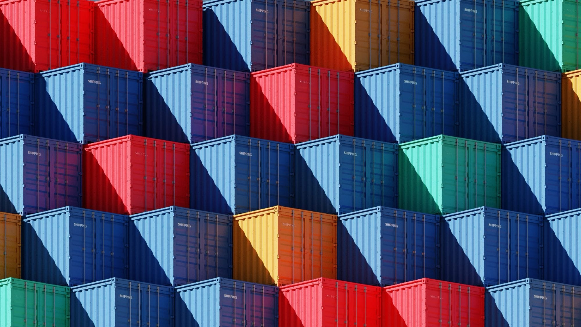 Stacked shipping containers in a colourful grid at a container terminal